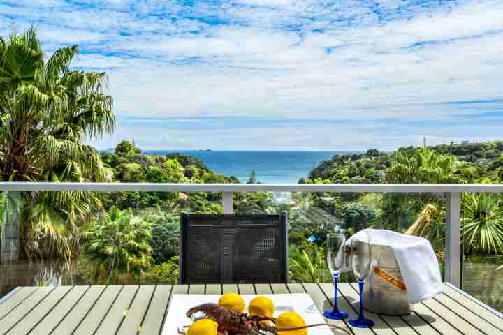Be my guest at private balcony with outdoor seating with view of Palm Beach, Waiheke