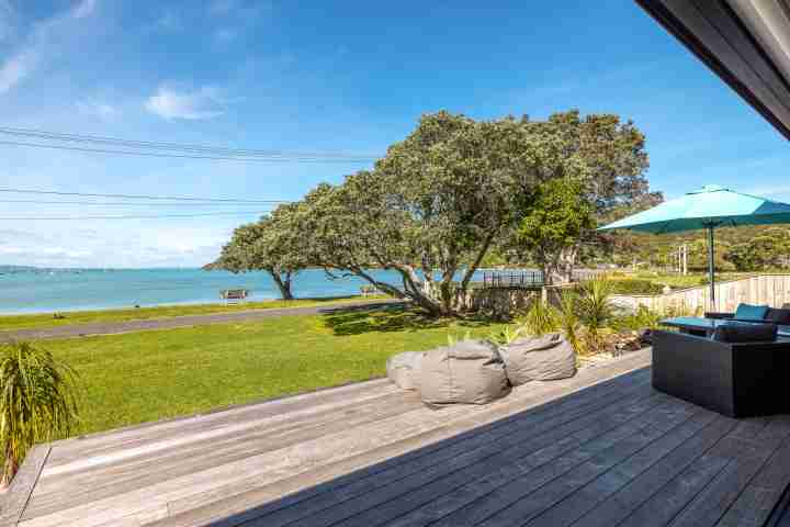 Expansive front deck Piritahi Beach House by Waiheke Unlimited