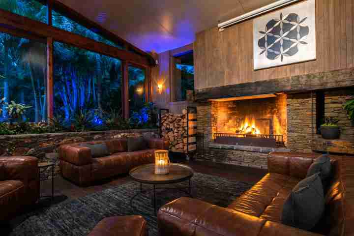 Fireplace and leather couches in luxury Waiheke Island lodge