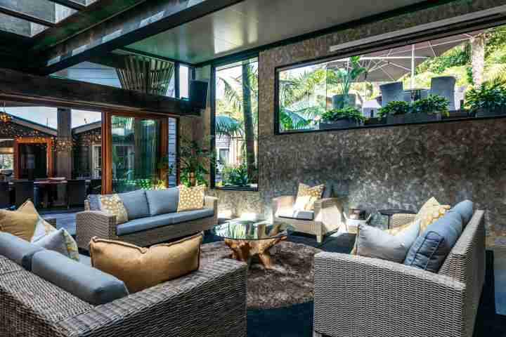 Formal lounge room with open-plan dining area at Kauri Springs lodge, corporate events Waiheke