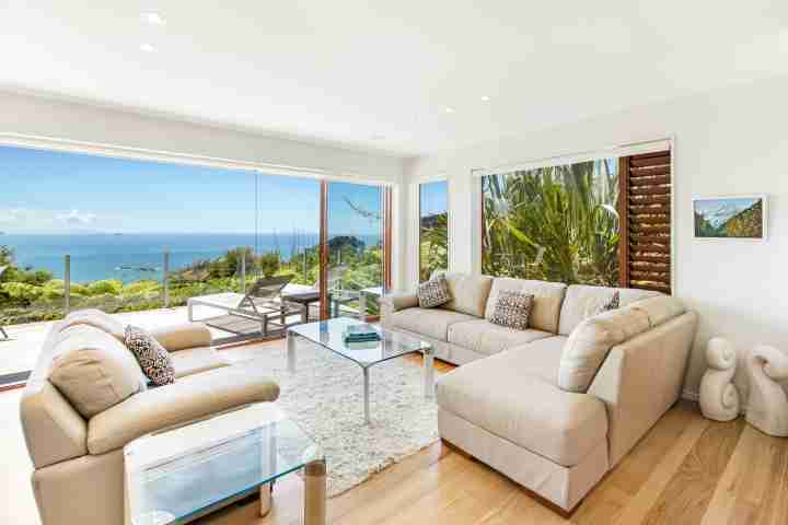 Open plan lounge with access to large sunny deck at modern family Villa