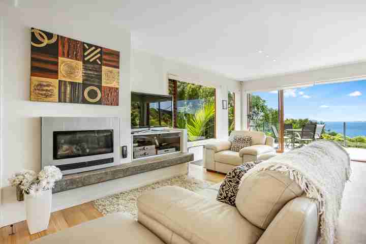 TV area and fireplace in modern comfortable family accommodation near Palm Beach