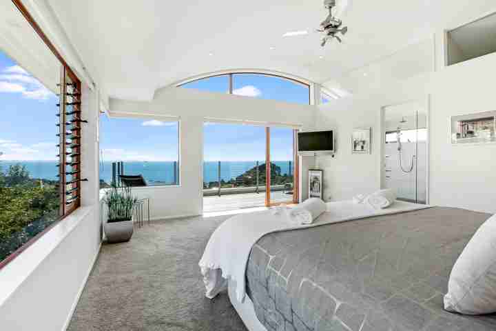 Large master bedroom with private balcony, ensuite bathroom and unlimited views