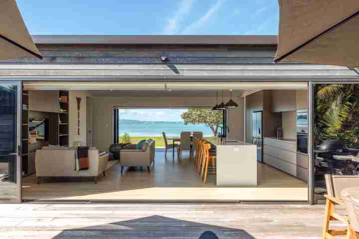 Indoor outdoor flow at Piritahi Beach House by Waiheke Unlimited