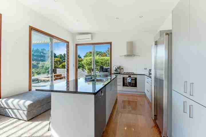 Fully-equipped self-catered kitchen with Nespresso Coffee Machine in spacious Waiheke family home