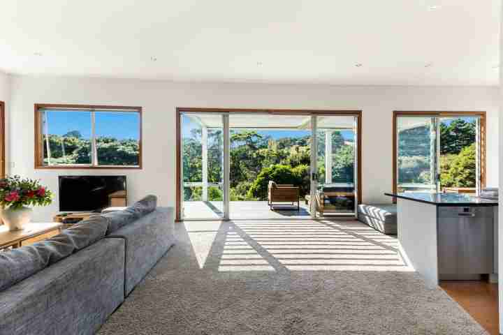 Comfortable lounge and TV room for entertaining family and guests at Karaka Sanctuary