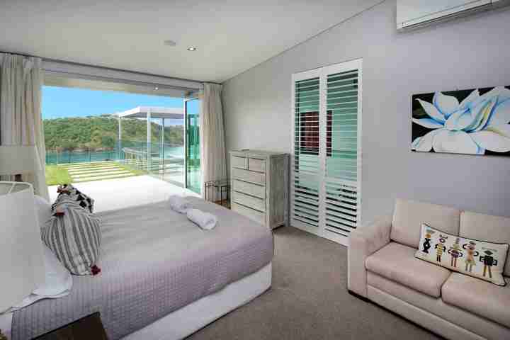 Stay in pure New Zealand luxury - private double bedroom with sea views