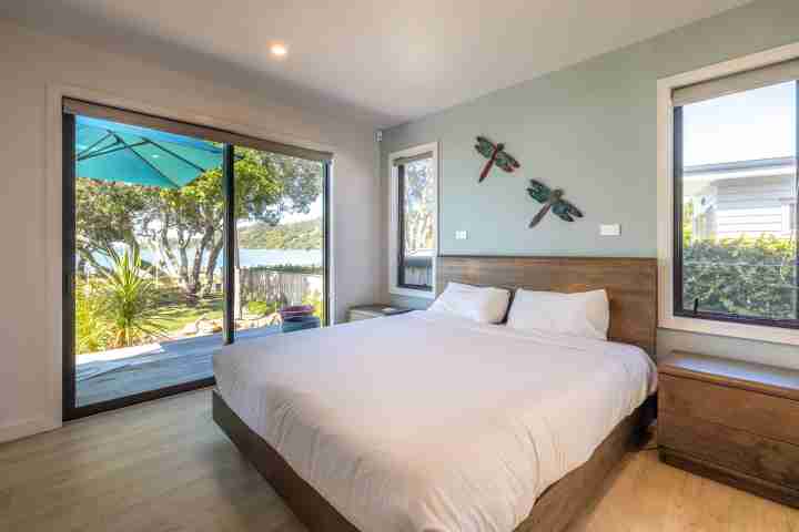 Master bedroom with views at Piritahi Beach House by Waiheke Unlimited