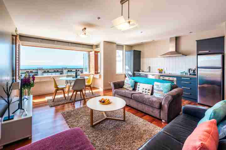 Premium apartment with open-plan lounge, dining and kitchen with Onetangi beach view