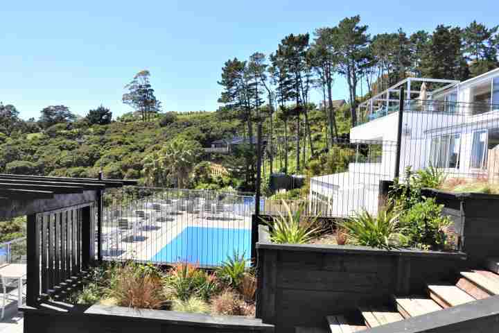 Relax and enjoy family time at the large outdoor swimming pool at the Waiheke Island Resort