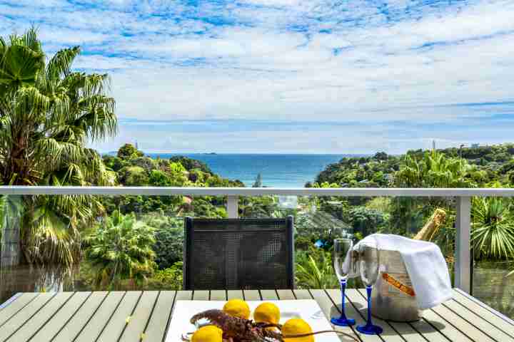 Dine at private balcony with unlimited views of New Zealand bush and Palm Beach